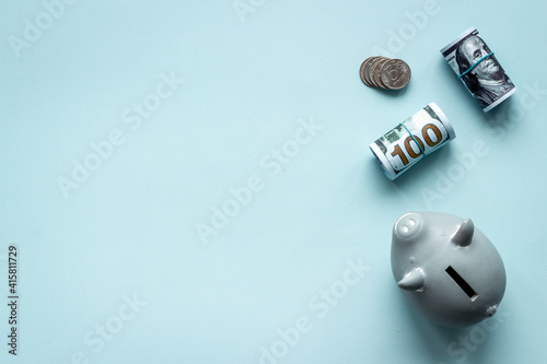 Obraz Dibond Saving money concept. Piggy bank with cash money and coins. Top view