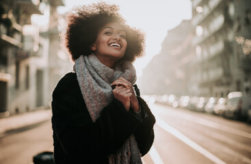 Beautiful girl with afro haircut walking on the street