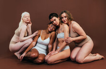 Group Of Multiethnic Women With Different Kind Of Skin Posing Together In Studio. Concept About Body Positivity And Self Acceptance