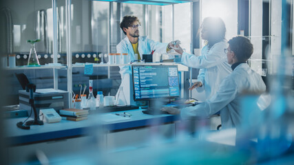 modern medicine research laboratory: diverse team of multi-ethnic young scientists passes samples in