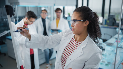 Wall Mural - medical science laboratory: beautiful black female scientist writes detailed project data analysis o