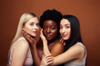 © iordani - young pretty asian, caucasian, afro woman posing cheerful together on brown background, lifestyle diverse nationality people concept