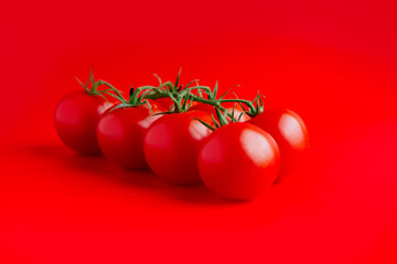 Bunch of fresh, red cherry tomatoes with green stems. soft light. copy space. top view
