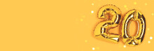 Banner With Number 20 Golden Balloons With Copy Space. Twenty Years Anniversary Celebration Concept On A Yellow Background With Shiny Bokeh.