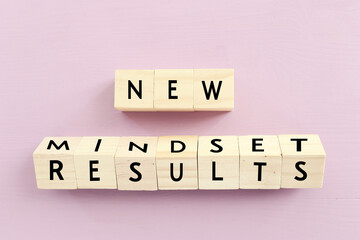 Poster - concept image with new mindset new results text over wooden cubes