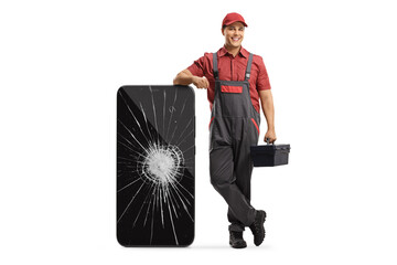 Wall Mural - Mobile phone repair technician leaning on a smartphone with a broken screen