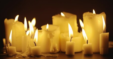 Wall Mural - Candles glowing against dark background