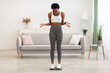 © Prostock-studio - Displeased Black Woman Standing On Scales Weighing Herself At Home