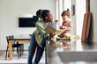 © Flamingo Images - Mom and little daughter reading a storybook and eating a snack