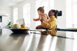 © Flamingo Images - Young mom looking after her girl while working from home.