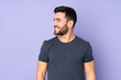 © luismolinero - Caucasian handsome man looking side over isolated purple background