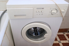 An Old Broken Washing Machine In A Bathroom Need To Be Recycled And Replaced