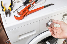 Laundry Washing Machine Repair Concept. Handyman Fix Washing Appliance
