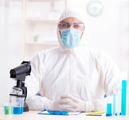 Young chemist student working in lab on chemicals