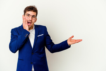 Wall Mural - Young business caucasian man isolated on white background impressed holding copy space on palm.