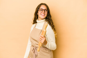 Wall Mural - Young caucasian chef woman isolated looks aside smiling, cheerful and pleasant.