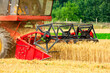 © zhengzaishanchu - combine harvester working on a wheat field