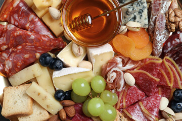 Wall Mural - Different appetizers with delicious honey as background, top view