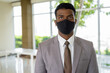 © Ranta Images - Portrait of African businessman with surgical medical mask for protection