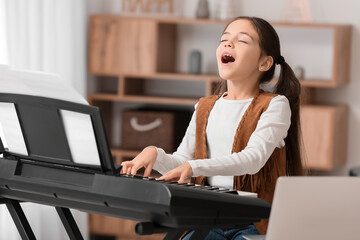 Poster - Little girl taking music lessons online at home