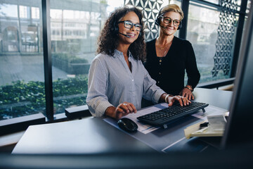 Wall Mural - Two business professionals working together in office