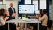 © DC Studio - Succesful business man presenting the good evolution of company using digital interactive whiteboard with growth analysis, charts, statistics, data, Diverse people congratulate him clapping