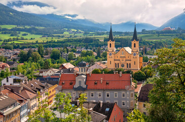 Wall Mural - Church of the Assumption of Mary in the old town of Brunico (Bruneck), South Tyrol, Italy. Top view of the historic center of the old city.