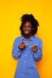 © iordani - young handsome african american guy student posing cheerful and gesturing on yellow background, lifestyle people concept
