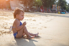 Adorable Toddler Girl Playing On Sandy Beach Of Tropical Island