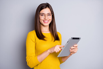 Wall Mural - photo of optimistic brunette nice lady hold tablet wear eyewear yellow sweater isolated on grey colo