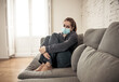 © SB Arts Media - Lonely woman suffering from depression at home during coronavirus lockdown and social distancing