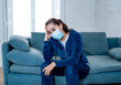 © SB Arts Media - Lonely woman suffering from depression at home during coronavirus lockdown and social distancing
