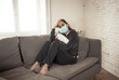 © SB Arts Media - Lonely woman suffering from depression at home during coronavirus lockdown and social distancing