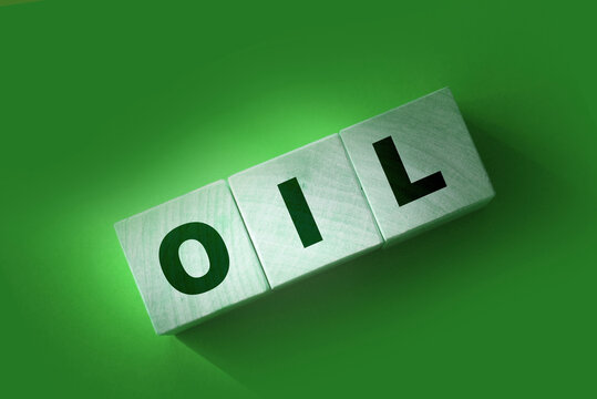 word OIL on cube blocks on red. World Economics business concept