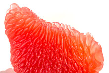 Fresh Juicy Grapefruit Pulp Background. Piece Of Red Grapefruit Macro Close Up. Citrus Fruit Texture Wallpaper