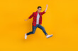 © deagreez - Full size profile side photo of young happy excited funky man in glasses running fast in air isolated on yellow color background