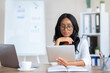 © Prostock-studio - Focused young black business lady using tablet pc at her workplace in modern office, copy space