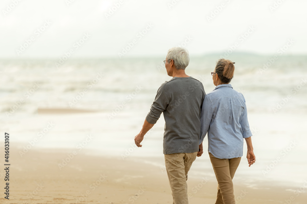Asian Lifestyle senior couple walking chill on the beach happy in love ...