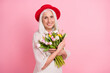 © deagreez - Portrait of attractive cheerful grey-haired granny holding in hands floral fresh tulips romance occasion isolated over pink pastel color background