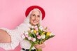 © deagreez - Self-portrait of attractive cheerful grey-haired retired pensioner elderly granny holding fresh tulips occasion isolated over pink pastel color background