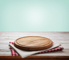 Napkin and board for pizza on wooden desk. Kitchen background.