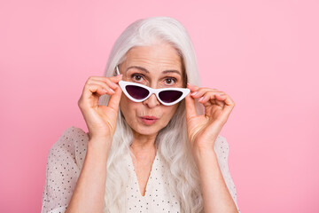 Poster - Close-up portrait of attractive amazed grey-haired woman touching specs pout lips isolated over pink pastel color background