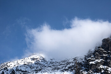 cloud on top of the mountain. Italian Alps