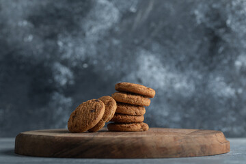 Delicious cookies with chocolate on a wooden board