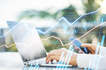 Poster - World stock market concept with businessman using laptop and smartphone and digital screen with forex chart data