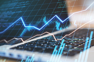 Poster - Growing diagram with financial graphs on digital screen at blurry laptop background