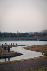 Wall Mural - Small stream of water reaching a lake called Råbysjön in the end of the city Lund in Sweden