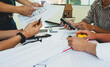 © Wasan - Team of architects working together to brainstorm and design a construction project. Project design inspectors work at the construction desk.