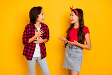 Photo Of Funny Cheerful Kids Talk Look Each Other Laughing Have Good Mood Isolated On Yellow Color Background