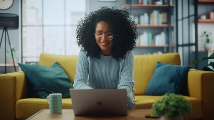 Aufkleber - Portrait of a Beautiful Authentic Latina Female in a Stylish Cozy Living Room Using Laptop Computer at Home. She's Browsing the Internet and Checking Videos on Social Networks and Having Fun.